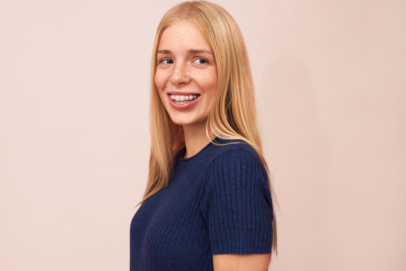Young woman with braces smiling confidently after orthodontic treatment at Marina Milstein Orthodontics Granite Bay